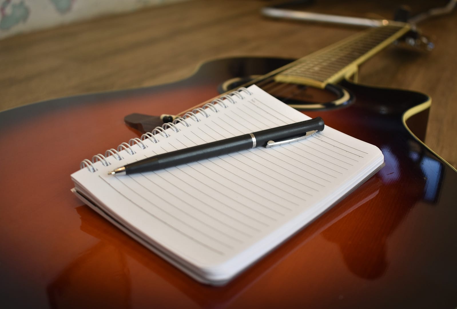 Notebook, pen and guitar