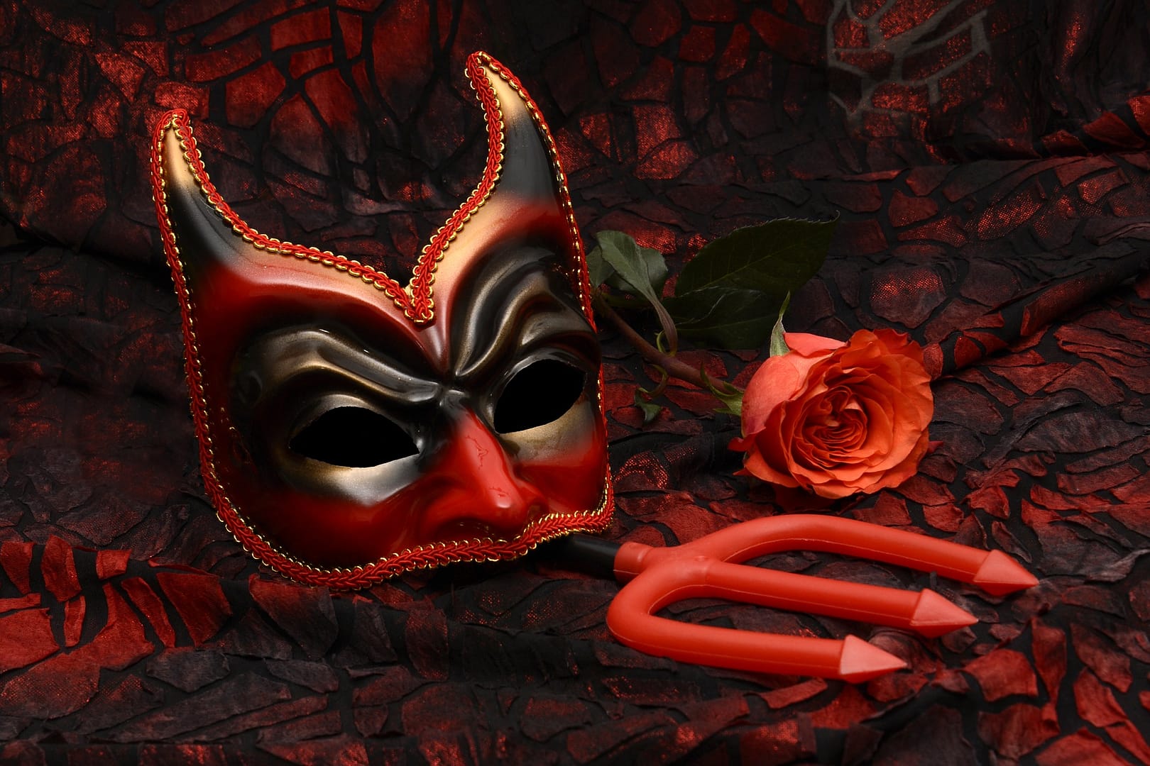 Demon mask, trident and red rose