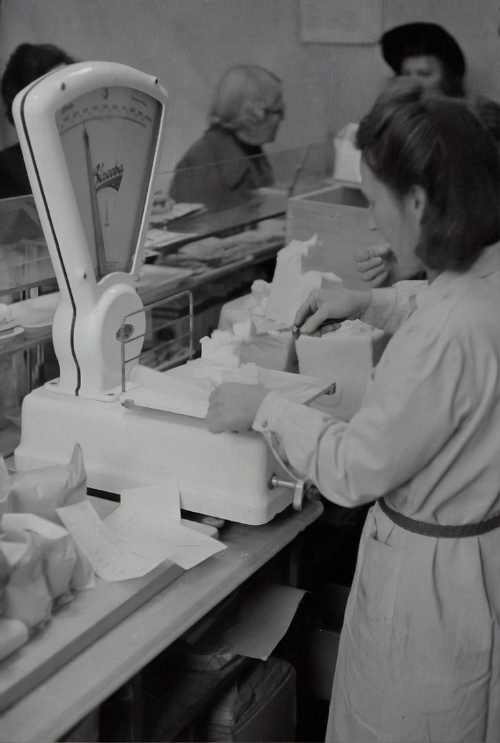 woman weighing cheese
